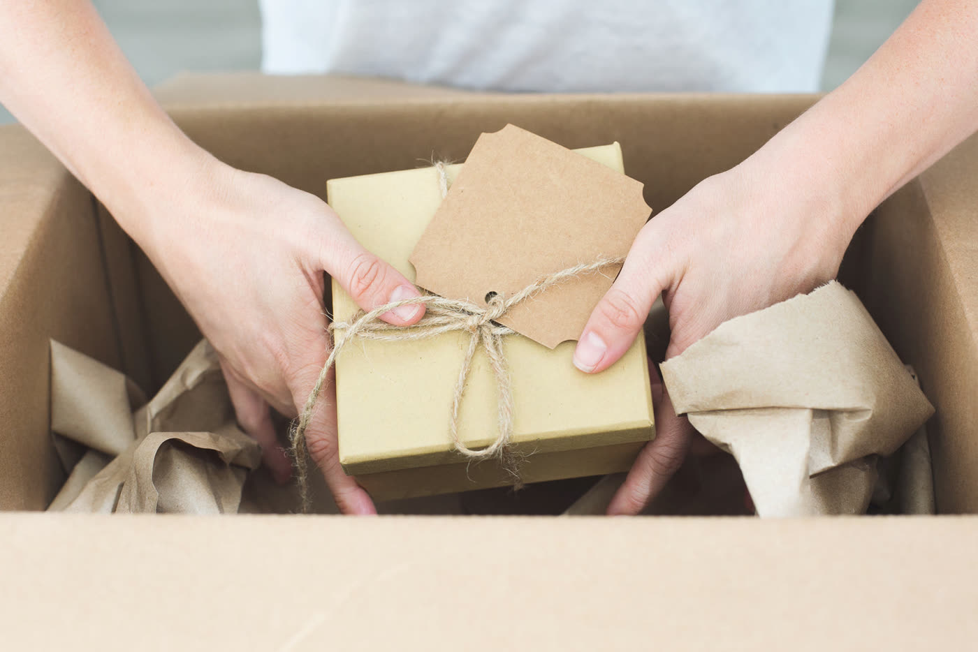 The tee packed in a box, ready to send