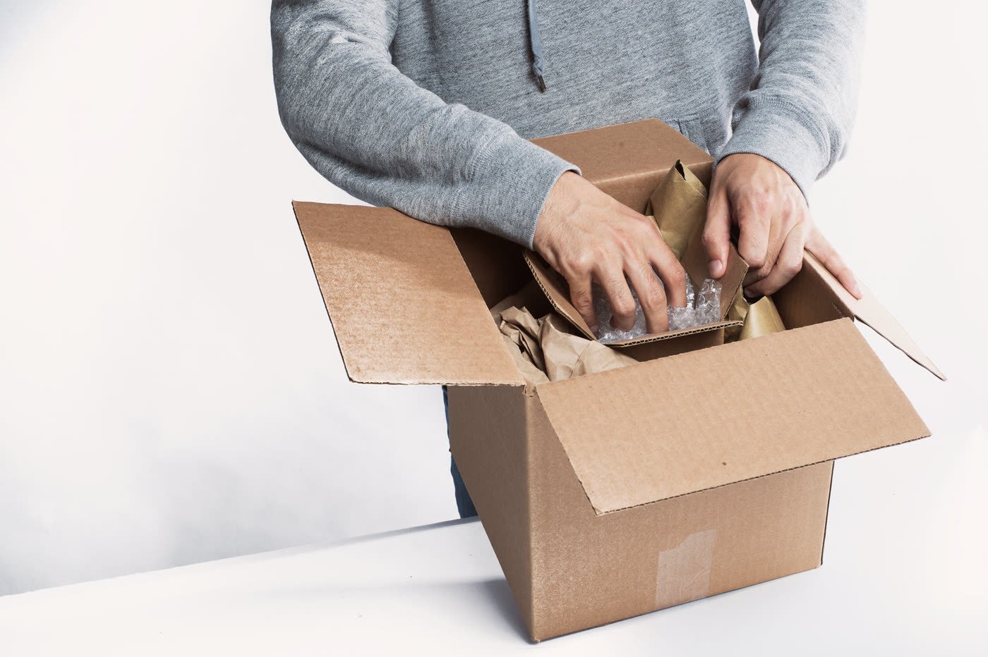 Daniel opens the returned parcel in his studio